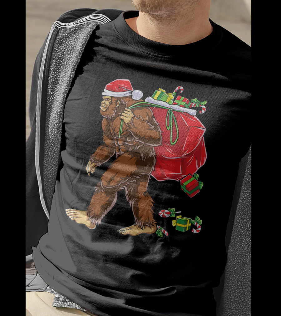 Bigfoot Santa With Giant Red Christmas Bag And Green Gifts Wearing Xmas Hat T-Shirt