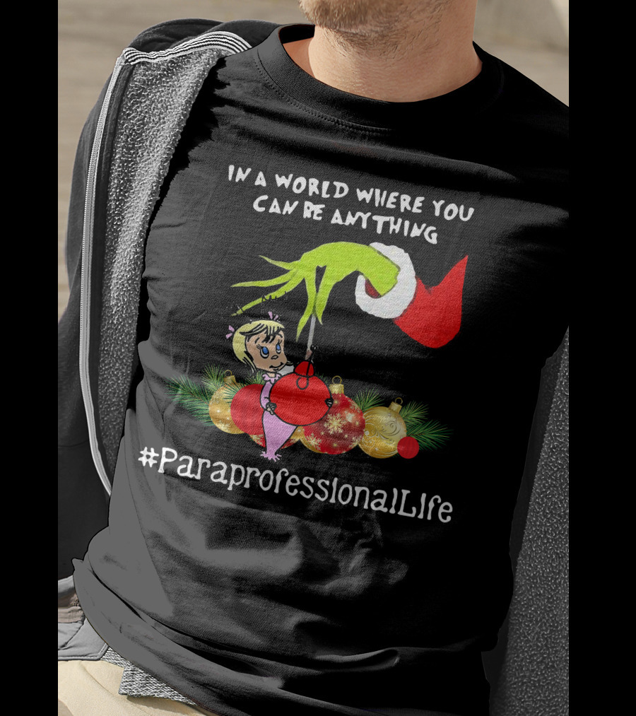 In A World Where You Can Be Anything Hand Grinch Holding Ornaments #ParaprofessionalLife T-Shirt