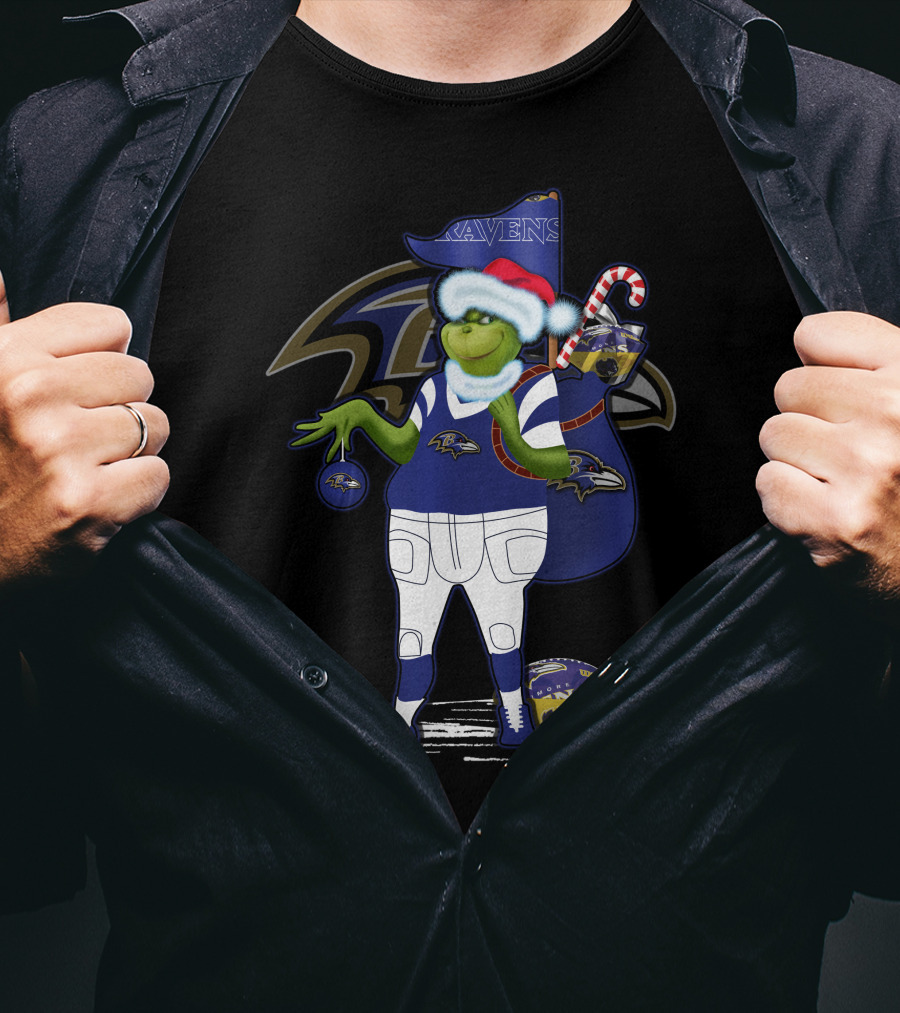 Grinch Santa Holding Candy Cane Bag And Baltimore Ravens Football In Ravens T-Shirt