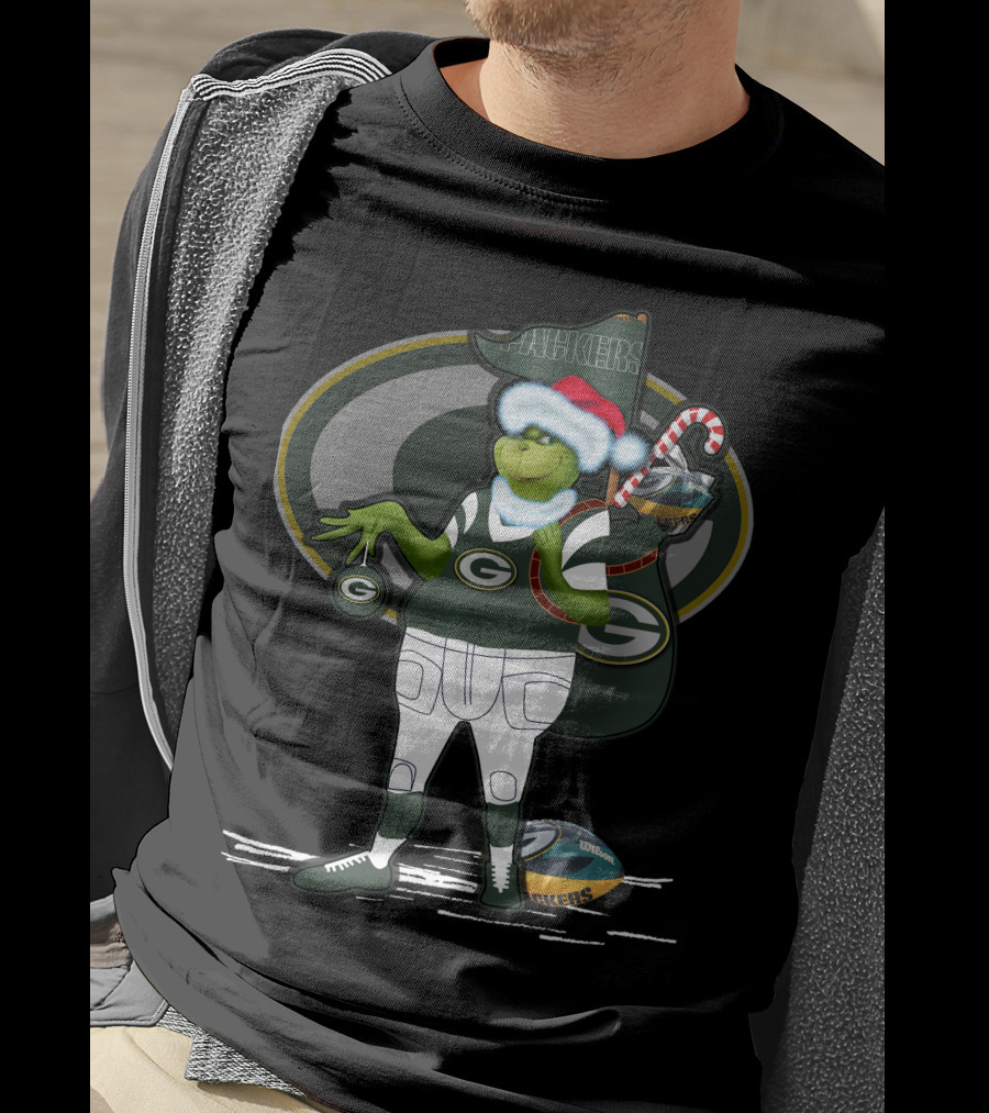 Grinchxmas Green Bay Packers Santa Hat Grinch Holding Helmet And Candy Cane T-Shirt