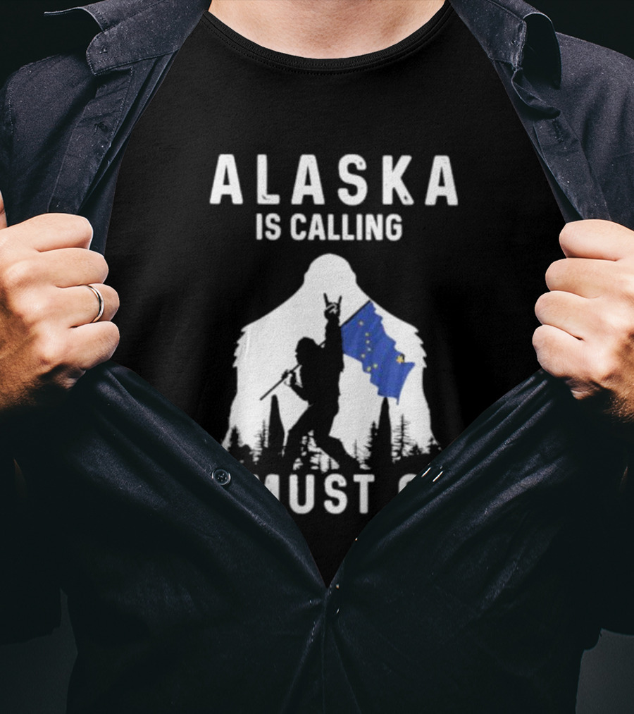 Alaska Is Calling I Must Go Bigfoot Holding Alaska Flag T-Shirt