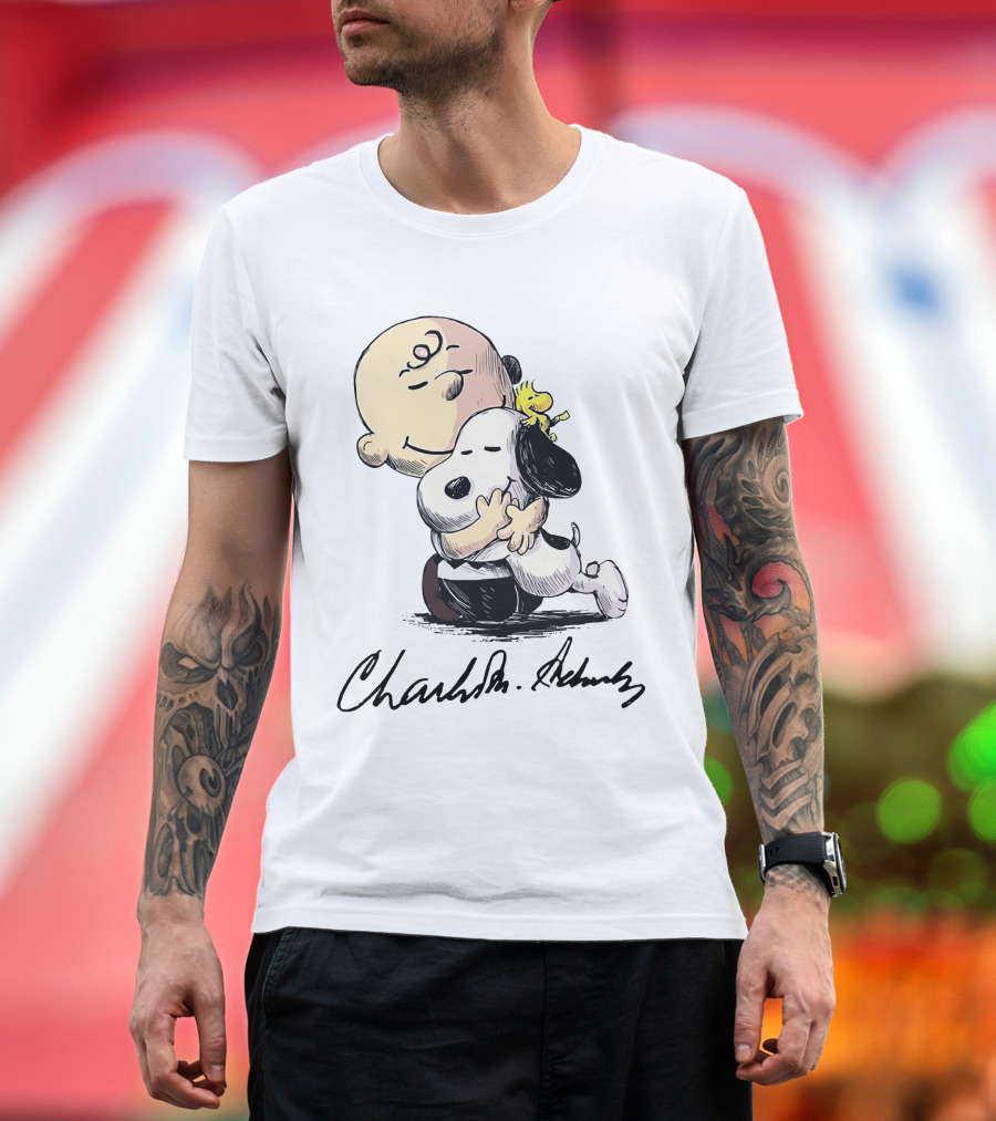 Snoopy and Charlie Brown Hugging by Charles M. Schulz T-Shirt