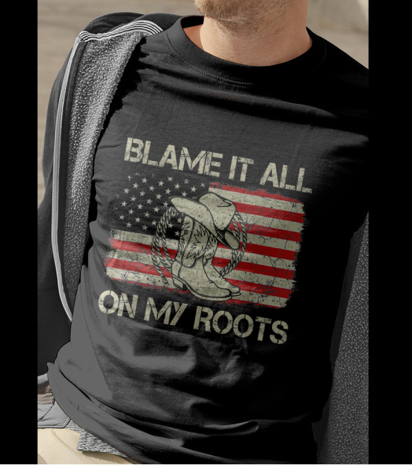 Blame It All On My Roots Cowboy Hat Boots American Flag Background T-Shirt
