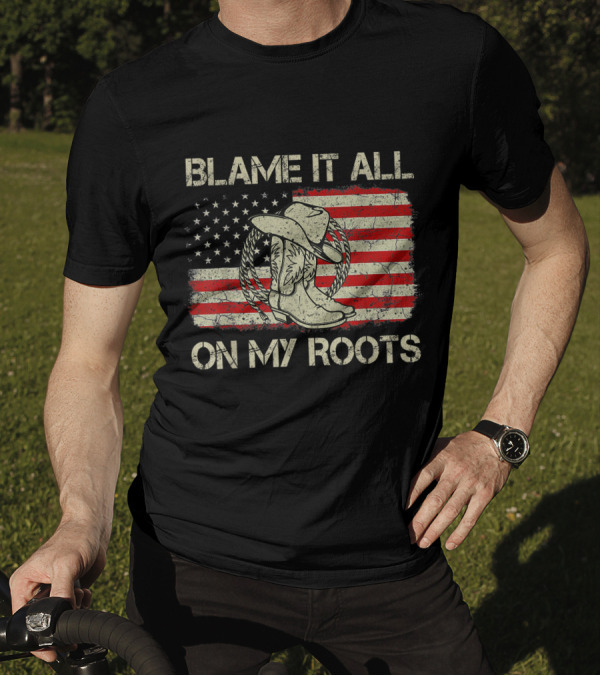 Blame It All On My Roots Cowboy Hat Boots American Flag Background T-Shirt