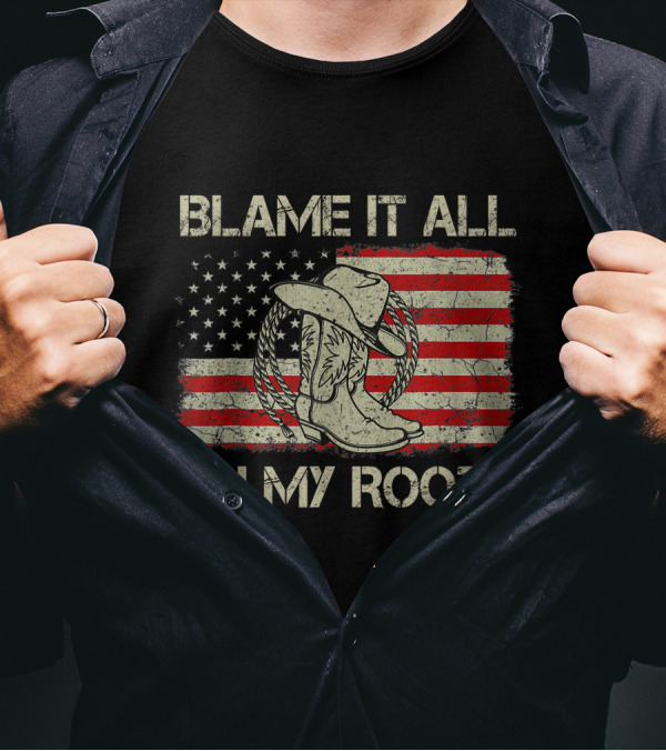 Blame It All On My Roots Cowboy Hat Boots American Flag Background T-Shirt