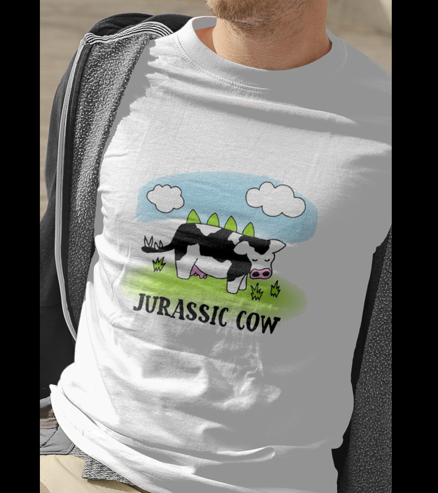 Jurassic Cow Grazing With Dinosaur Spikes Under Blue Sky And Clouds In Cartoon T-Shirt