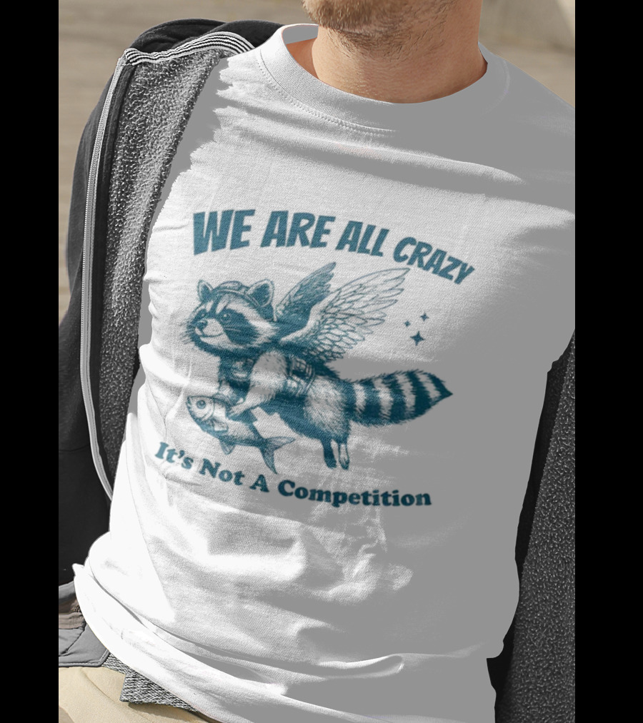 Raccoon With Wings Holding Fish We Are All Crazy It's Not A Competition T-Shirt