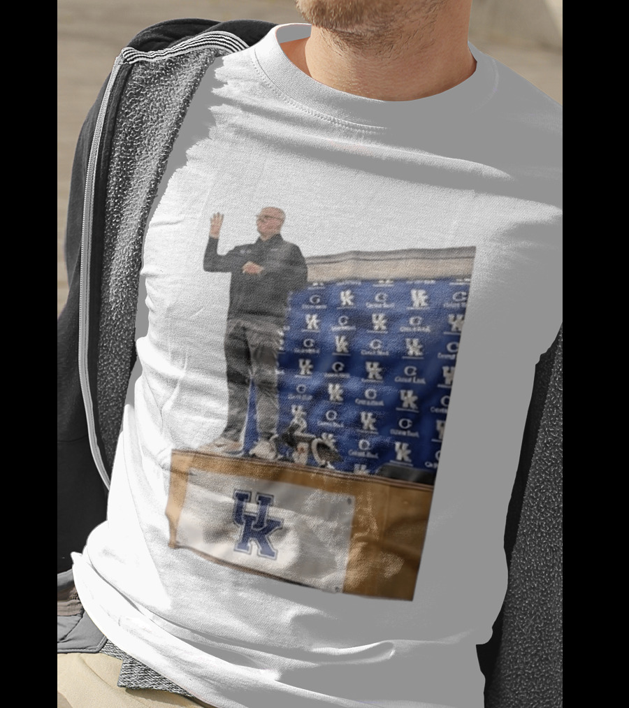 UK Volleyball Coach Craig Skinner Standing On Table With UK Logo And Awards T-Shirt