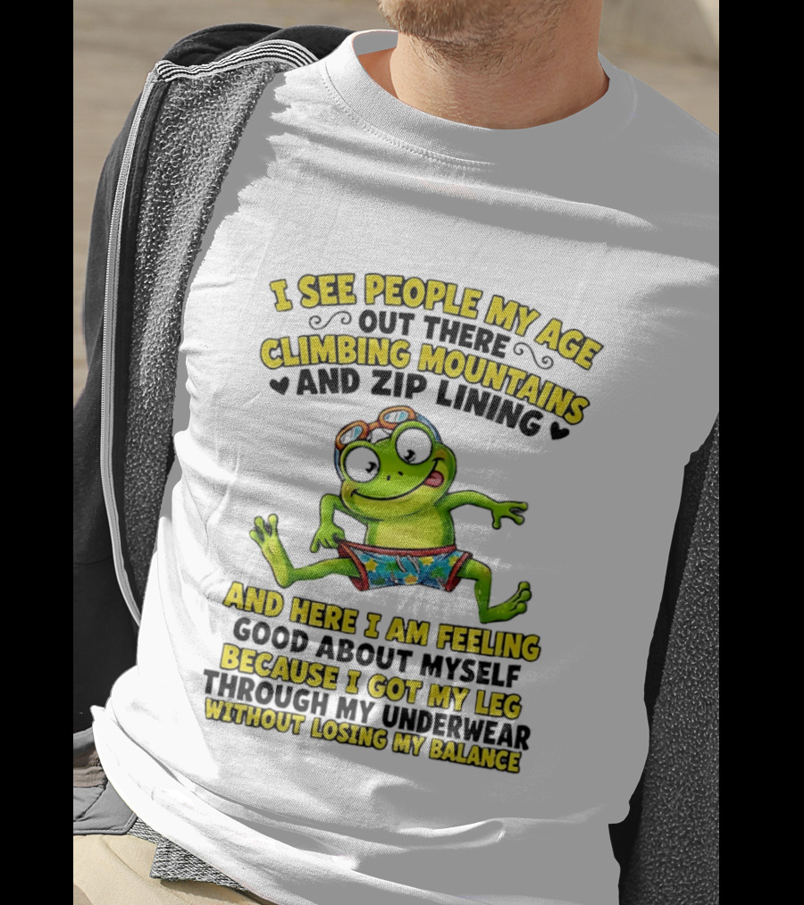 I See People My Age Climbing Mountains And Zip Lining Cartoon Frog Feeling Good Without Losing Balance T-Shirt