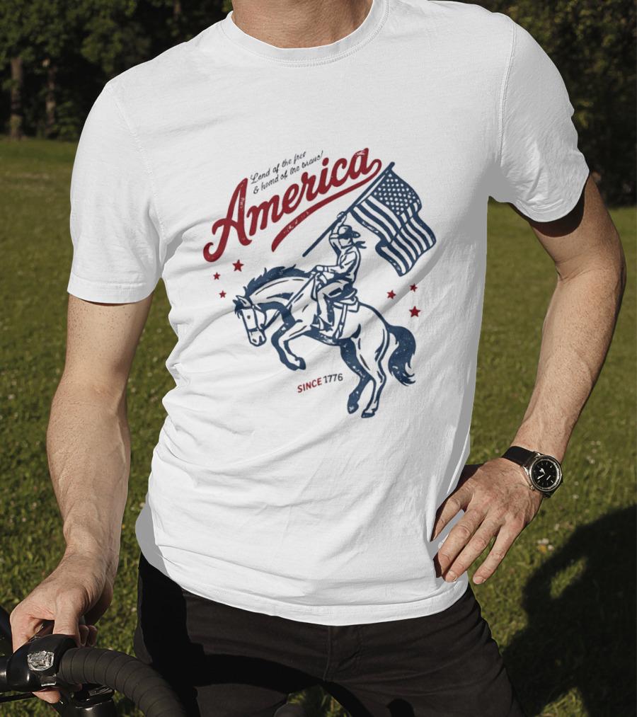 America Land Of The Free Home Of The Brave Since 1776 Cowboy Holding Flag Patriotic T-Shirt