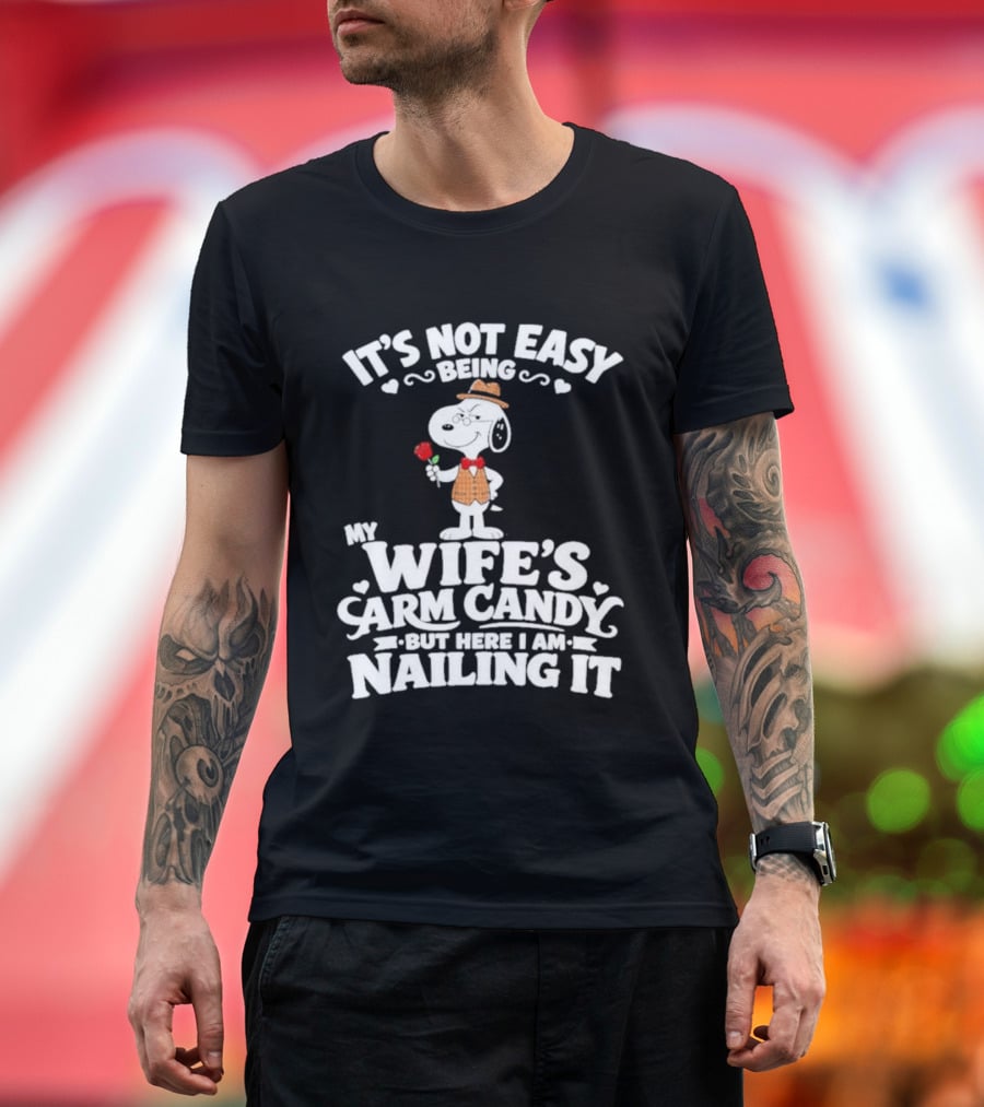Snoopy It's Not Easy Being My Wife's Arm Candy But Here I Am Nailing It T-Shirt