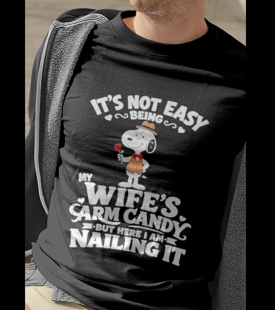 Snoopy It's Not Easy Being My Wife's Arm Candy But Here I Am Nailing It T-Shirt