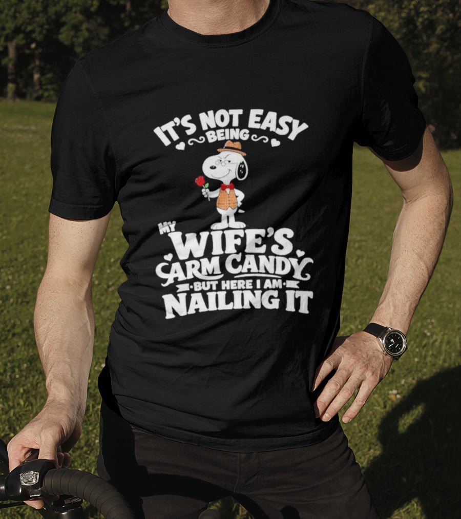 Snoopy It's Not Easy Being My Wife's Arm Candy But Here I Am Nailing It T-Shirt