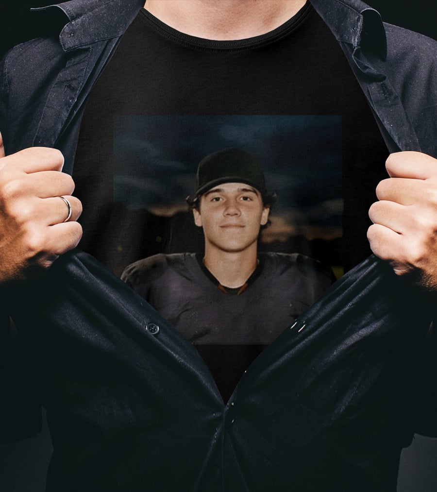 Young Football Athlete Wearing Black Cap And Shoulder Pads T-Shirt