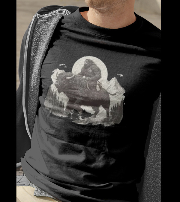 Blurry Creatures Bigfoot Riding Buffalo With Mountains And Moon In Background T-Shirt