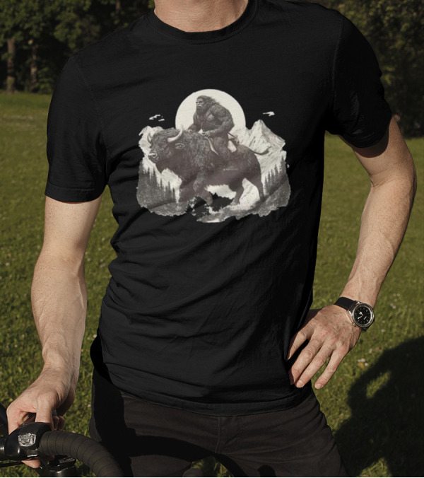 Blurry Creatures Bigfoot Riding Buffalo With Mountains And Moon In Background T-Shirt
