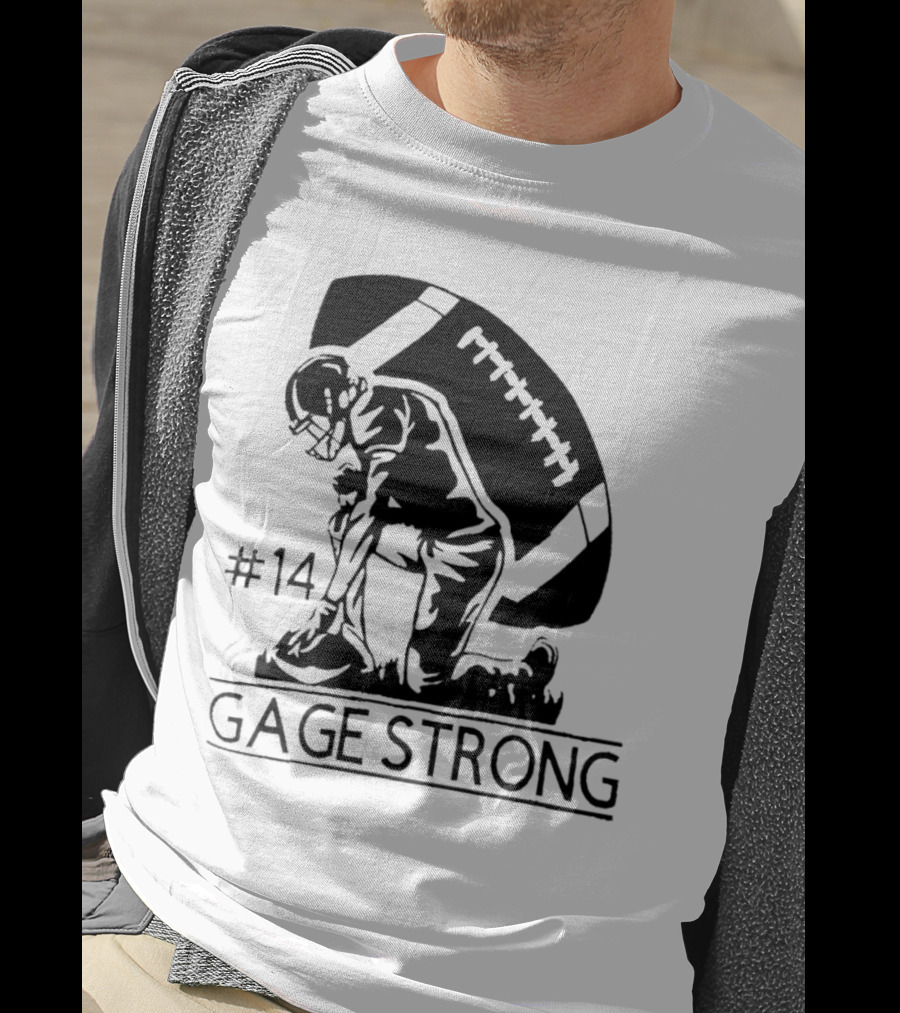 Gage Strong #14 Football Player Kneeling In Front Of Large Football T-Shirt