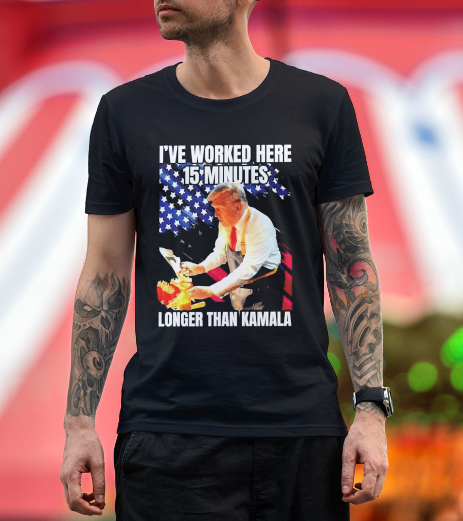 I’ve Worked Here 15 Minutes Longer Than Kamala Donald Trump American Flag Background T-Shirt