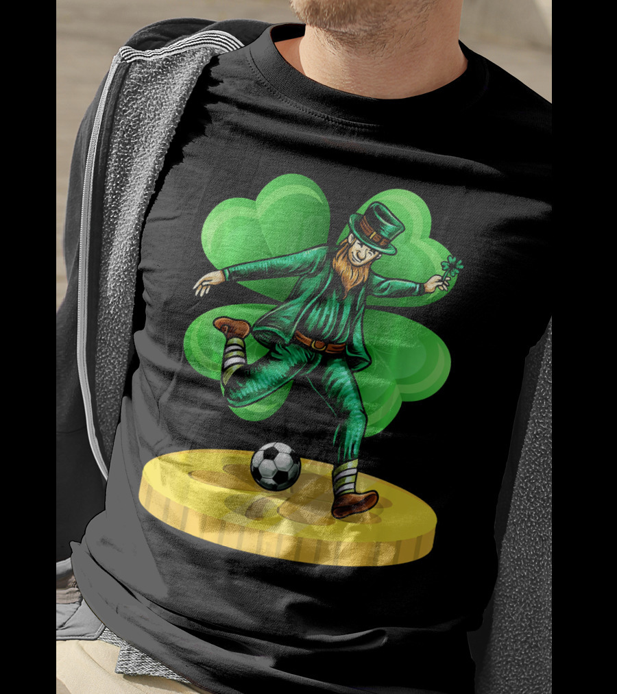 Leprechaun Kicking Soccer Ball On Gold Coin With Shamrock Background T-Shirt