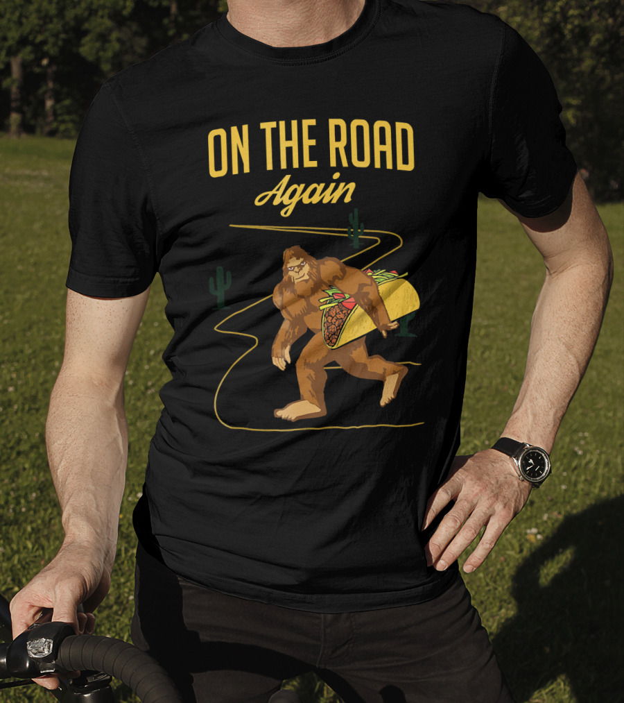 ON THE ROAD AGAIN Smirk Bigfoot Sasquatch Carrying Taco T-Shirt