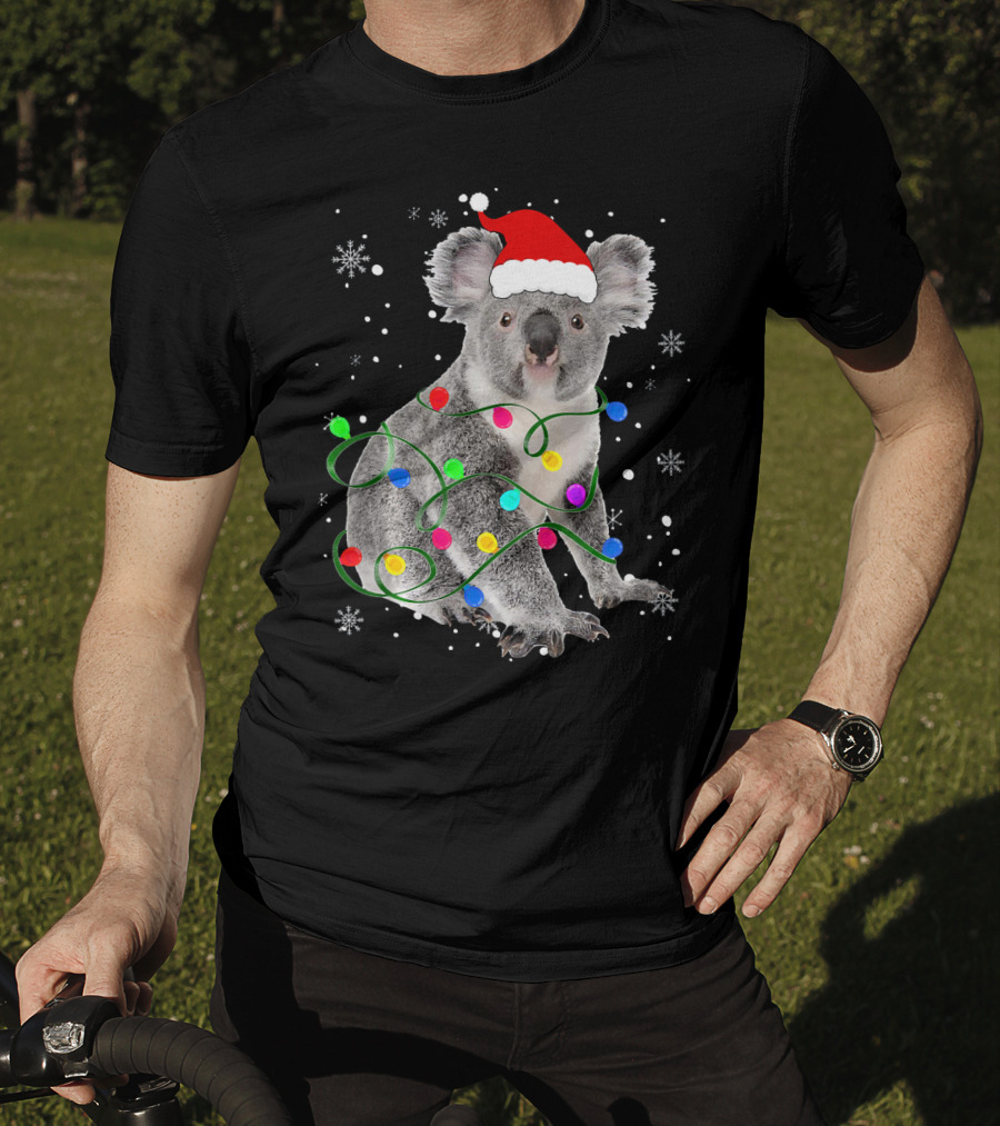 Koala Wrapped In Christmas Lights Wearing Santa Hat With Snowflakes Matching Fam T-Shirt