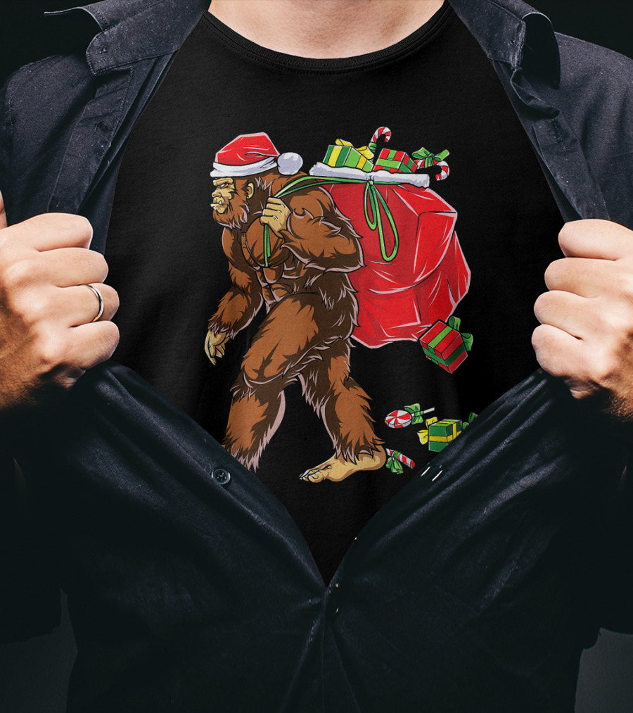 Bigfoot Santa Hat Carrying Christmas Presents And Candy Canes T-Shirt