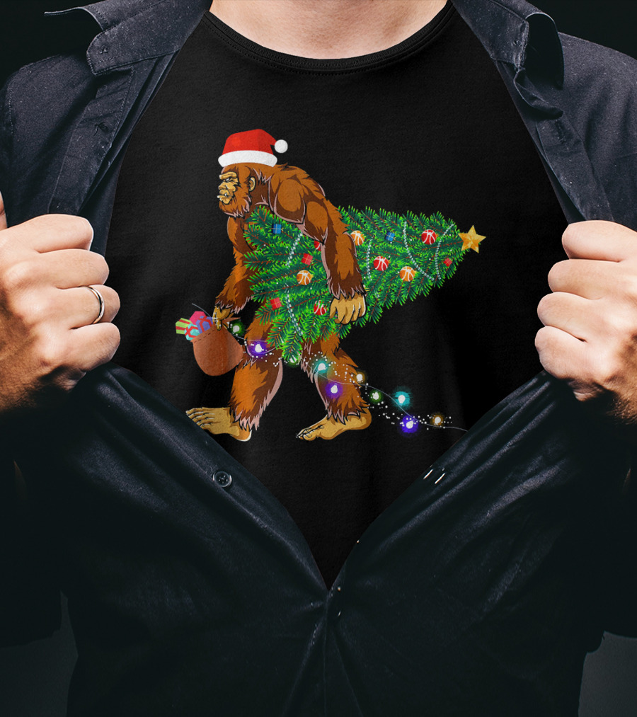 Santa Hat Bigfoot Holding Christmas Tree With Lights And Gifts T-Shirt