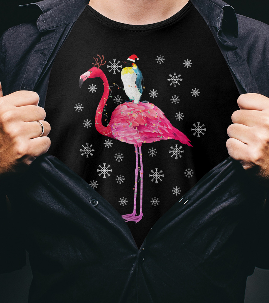 Penguin With Santa Hat Riding Flamingo With Antlers Surrounded By Snowflakes T-Shirt